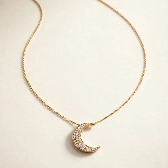 Crescent Moon Diamond Pendant, pavé-set crescent moon on a fine chain in yellow gold, full view.