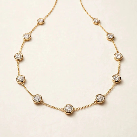 Diamonds by the Yard Necklace, bezel-set diamond stations along a fine chain in yellow gold, full view.