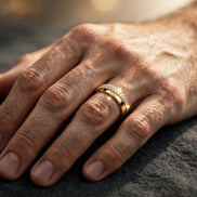 Half-pavé comfort-fit diamond band in yellow gold, worn on a man's ring finger — MARWAH