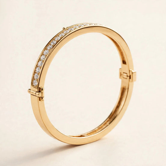 Hinged Diamond Bangle, round diamonds in a channel-set top arc in yellow gold, front view.