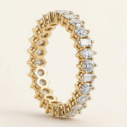 Mixed-Shape Eternity Band, alternating round, baguette, and marquise diamonds in a full eternity band in yellow gold, three-quarter detail view.