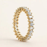 Mixed-Shape Eternity Band, alternating round, baguette, and marquise diamonds in a full eternity band in yellow gold, front view.
