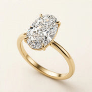 Oval Solitaire Ring, elongated oval lab-grown diamond in a four-prong setting on a plain band in yellow gold, front view.