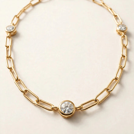 Paperclip Chain with Diamond Stations, elongated paperclip links with five bezel-set round diamonds in yellow gold, detail view.