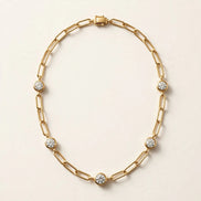 Paperclip Chain with Diamond Stations, elongated paperclip links with five bezel-set round diamonds in yellow gold, full view.
