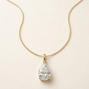 Pear Solitaire Pendant, pear-shaped diamond with point up in yellow gold, full view.