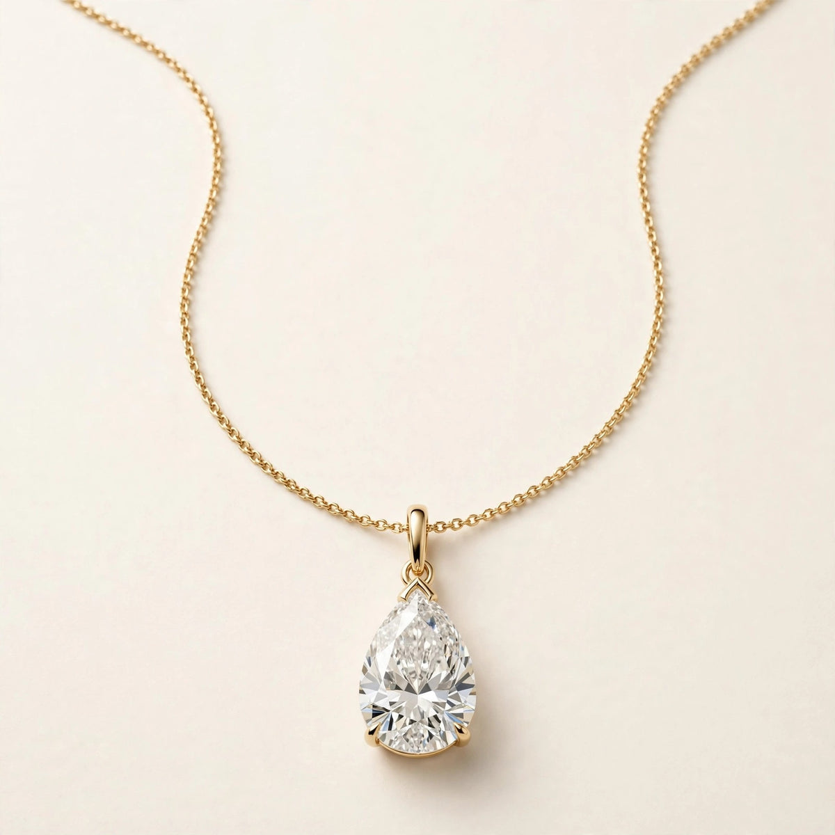Pear Solitaire Pendant, pear-shaped diamond with point up in yellow gold, full view.