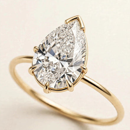 Pear Solitaire Ring, pear-cut lab-grown diamond with a V-prong tip on a fine plain band in yellow gold, three-quarter detail view.