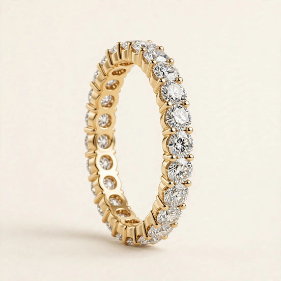 Round-Diamond Eternity Band, round brilliant diamonds in shared prongs in a full eternity band in yellow gold, front view.
