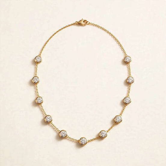 Round Diamond Station Necklace, evenly spaced bezel-set round diamonds on a fine chain in yellow gold, full view.