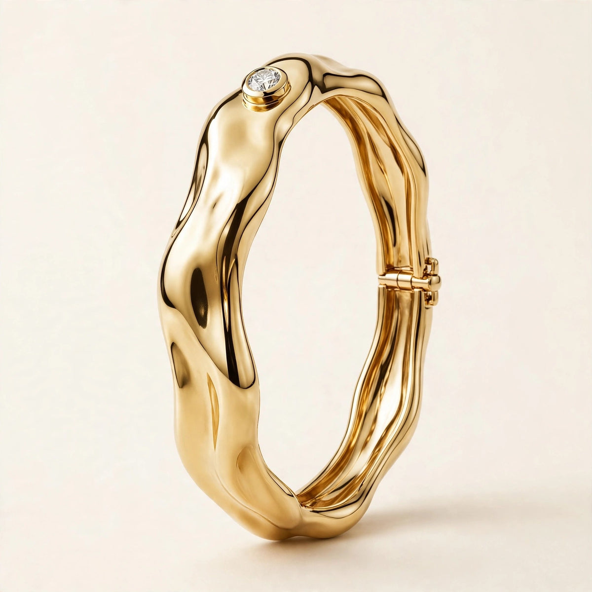Sculptural Gold Bangle with Diamond Accent, single bezel-set round diamond on a molten-form bangle in yellow gold, front view.