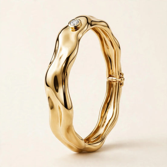 Sculptural Gold Bangle with Diamond Accent, single bezel-set round diamond on a molten-form bangle in yellow gold, front view.