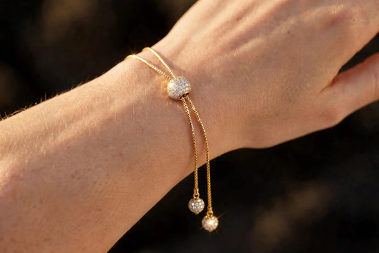 Diamond slider bolo bracelet in yellow gold worn on a woman's wrist, alternate view — MARWAH