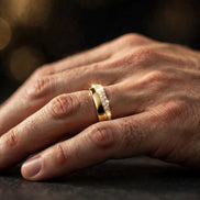 Half-pavé comfort-fit diamond band in yellow gold worn on a man's ring finger, alternate view — MARWAH